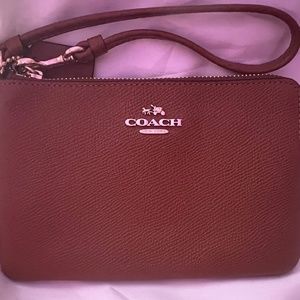 brown leather Coach wristlet